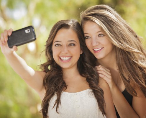 Two girls taking a selfie and smiling